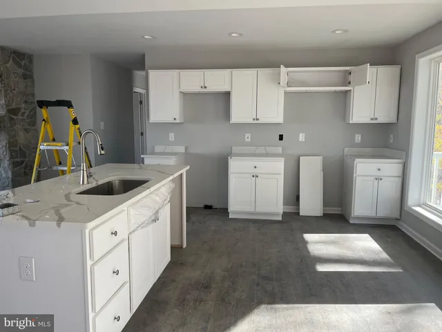 a kitchen with cabinets appliances and a sink