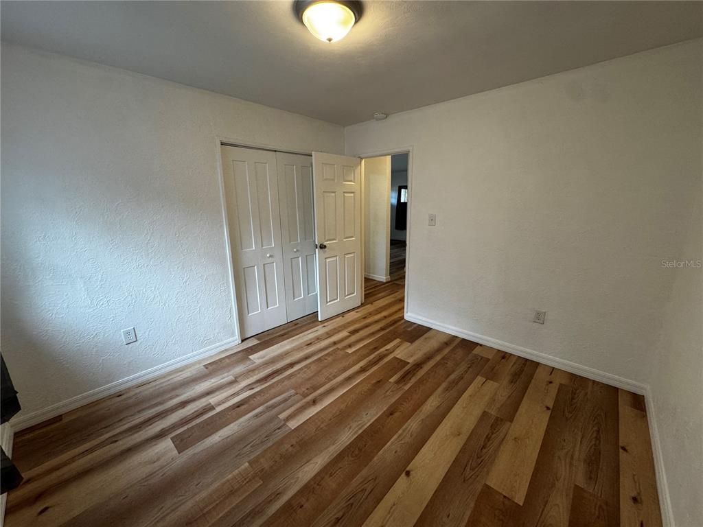 716 McCormack Street Leesburg, FL 34748 - Photo 8 of 13 a view of a room with wooden floor