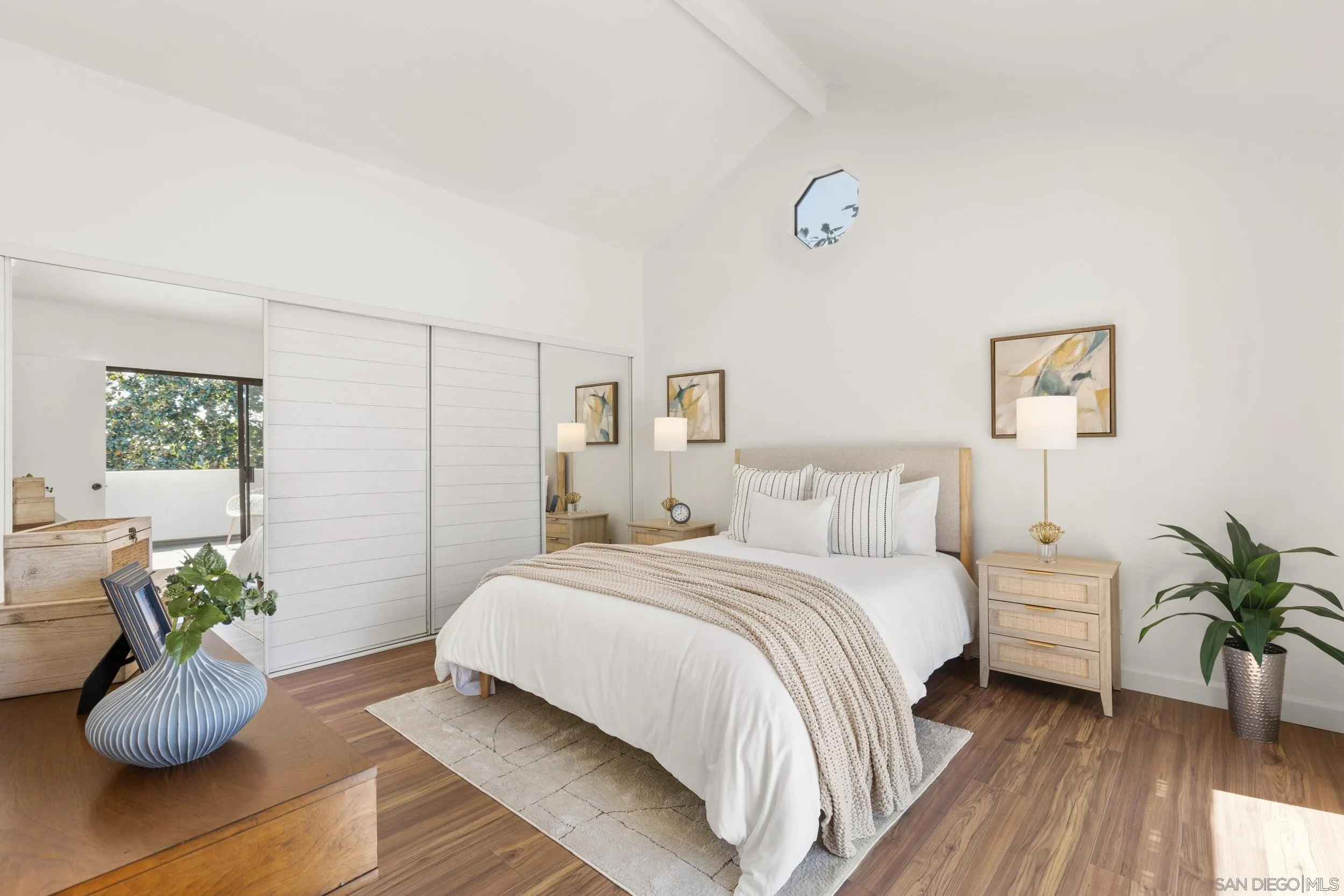 863 Violet Court Carlsbad, CA 92011 - Photo 16 of 37 a bedroom with a bed and potted plant