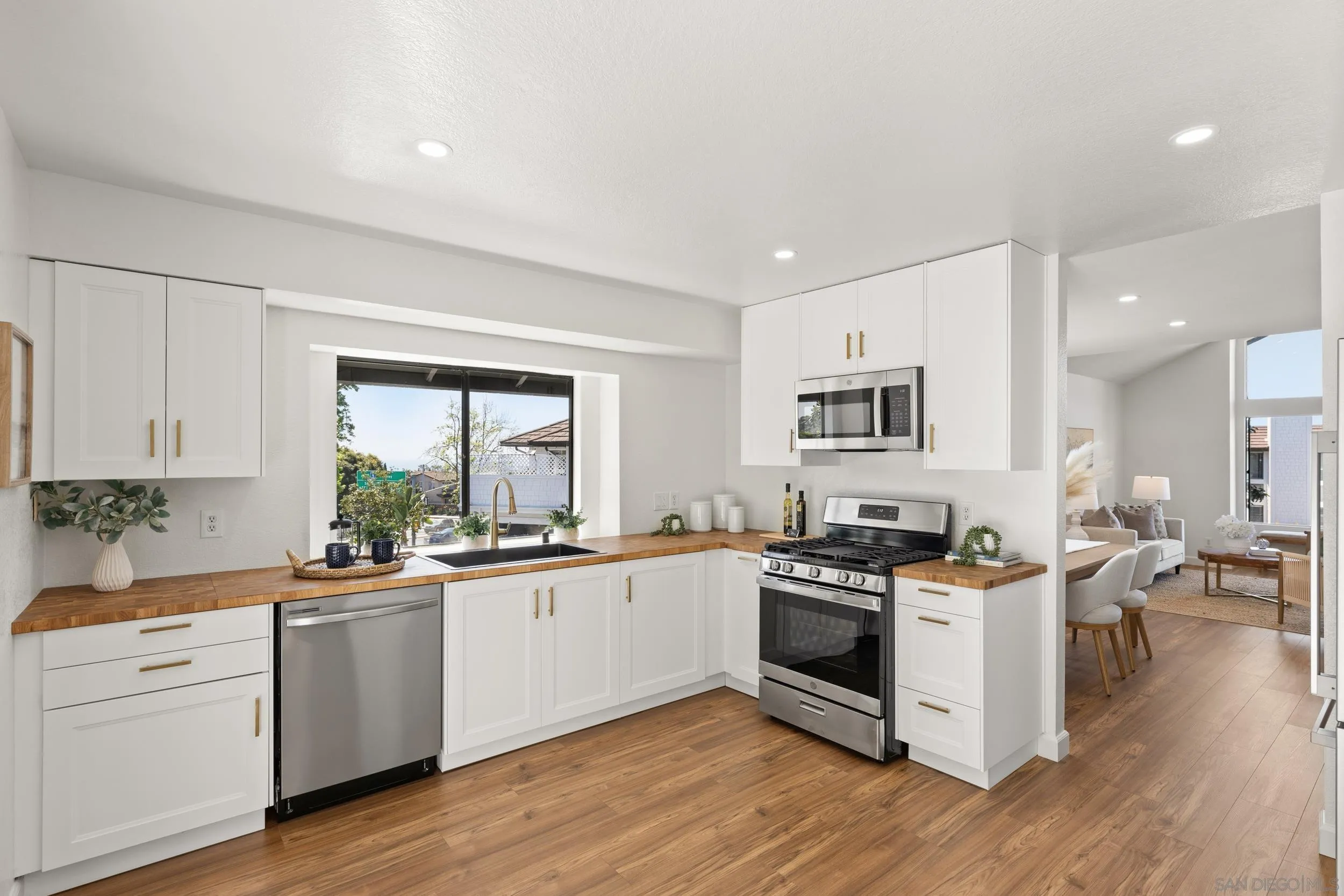 863 Violet Court Carlsbad, CA 92011 - Photo 10 of 37 a kitchen with stainless steel appliances a white stove top oven sink and cabinets
