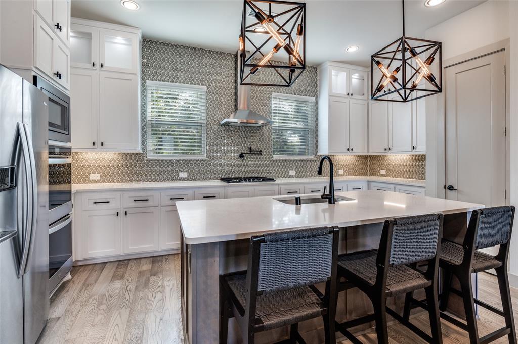 1434 Elevado Drive Dallas, TX 75212 - Photo 15 of 27 a kitchen with stainless steel appliances a sink stove and refrigerator