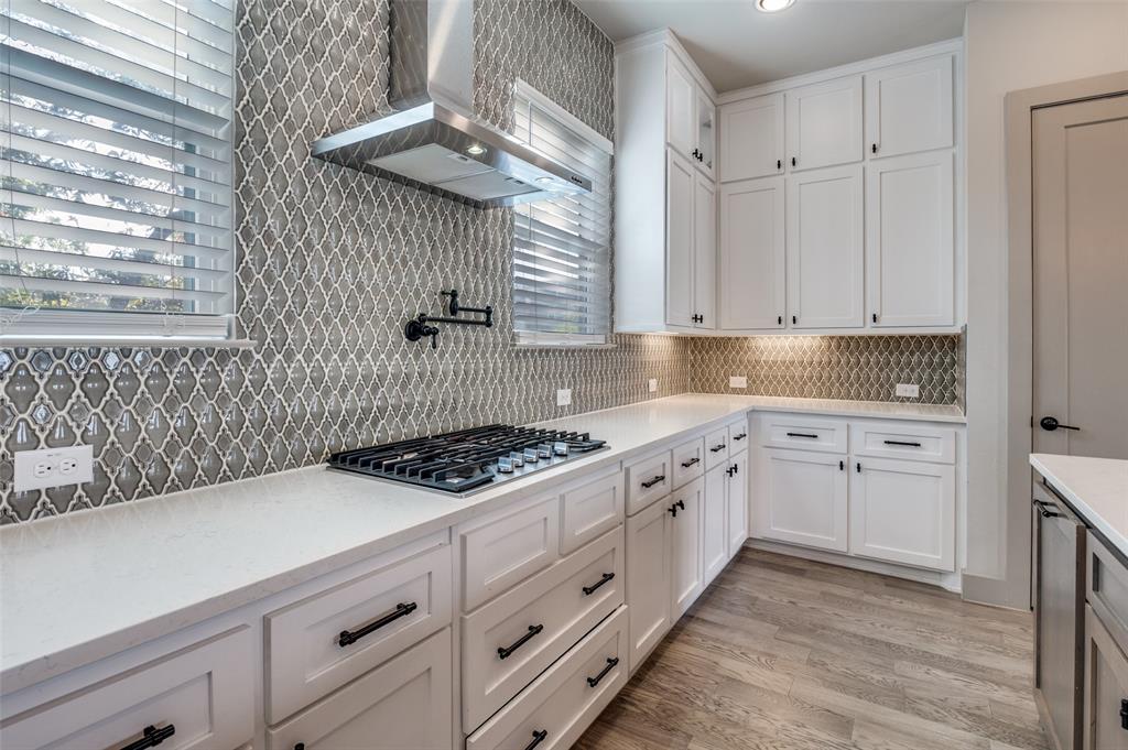 1434 Elevado Drive Dallas, TX 75212 - Photo 16 of 27 a kitchen with granite countertop a sink a stove and cabinets