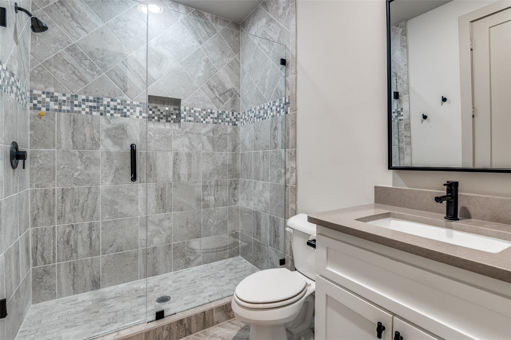 1434 Elevado Drive Dallas, TX 75212 - Photo 22 of 27 a bathroom with a sink a toilet and shower