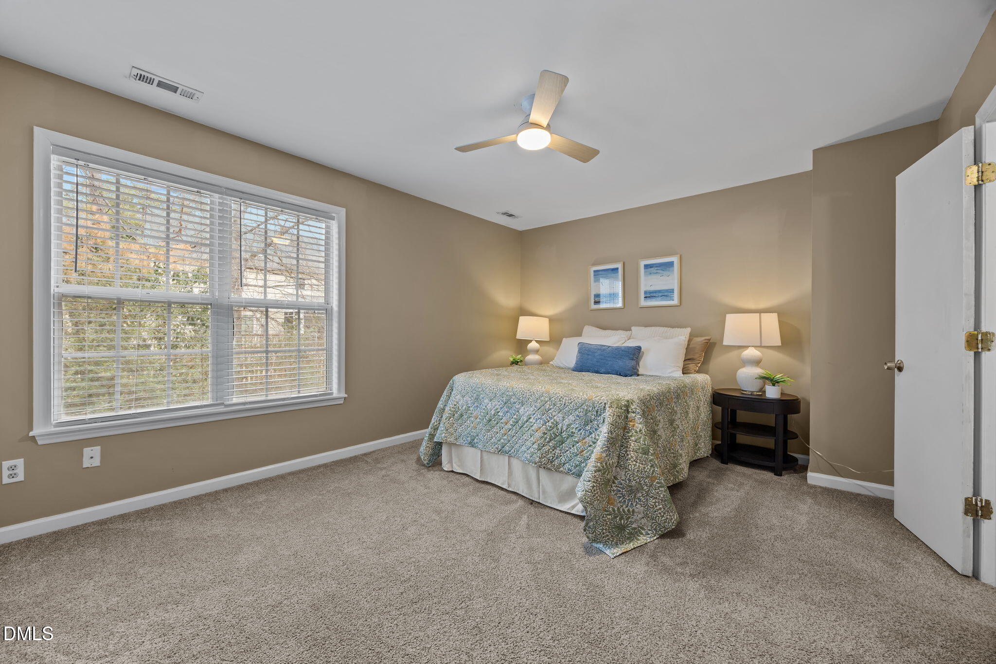 8606 London Park Court Raleigh, NC 27615 - Photo 10 of 29 a spacious bedroom with a bed and a chandelier