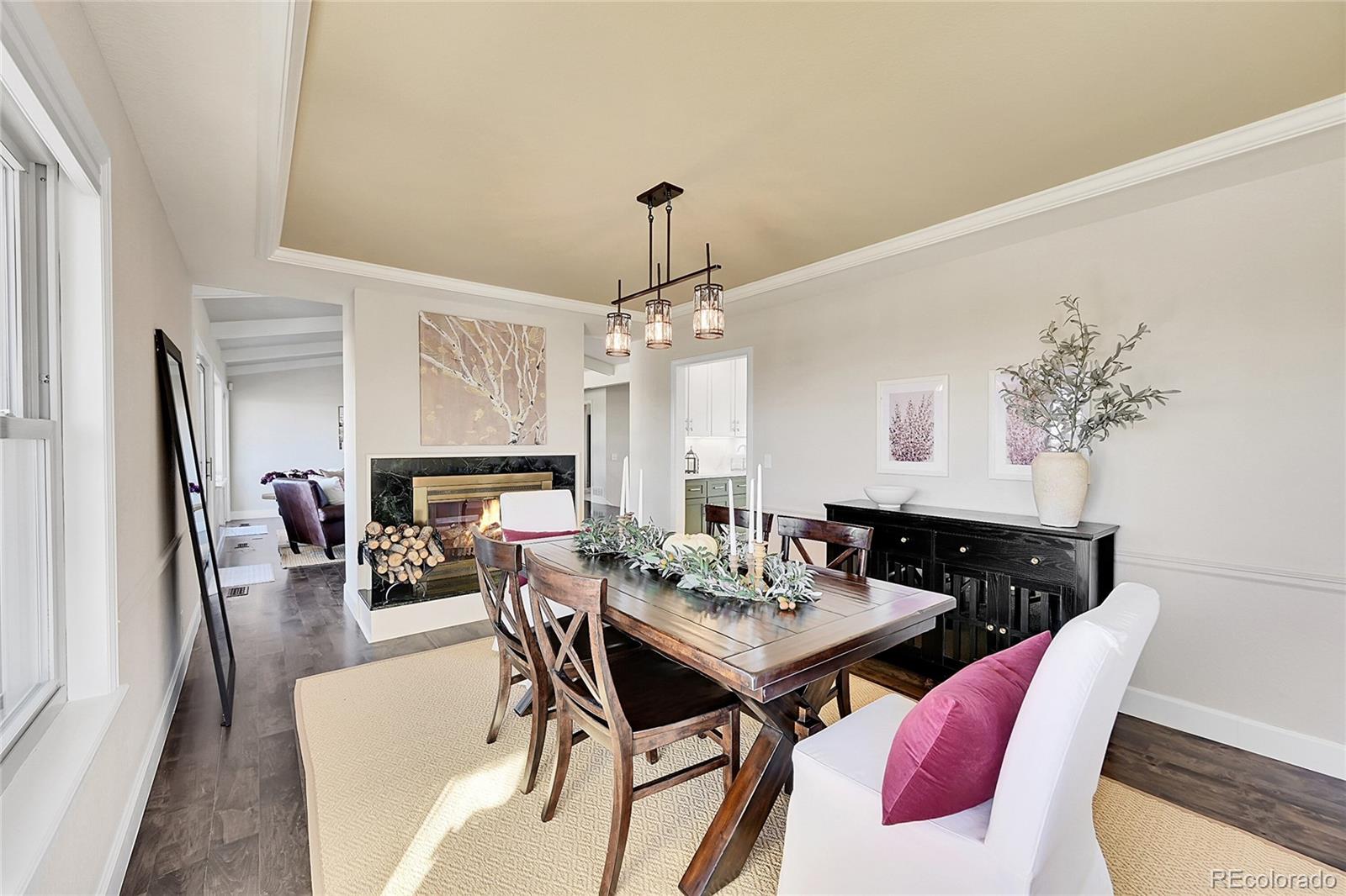 8717 Thunderbird Circle Parker, CO 80134 - Photo 12 of 50 a view of a dining room with furniture and wooden floor