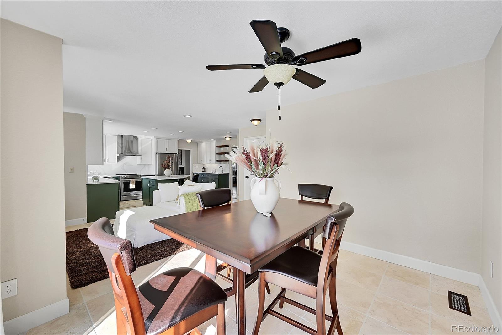 8717 Thunderbird Circle Parker, CO 80134 - Photo 21 of 50 a view of a dining room with furniture and a potted plant