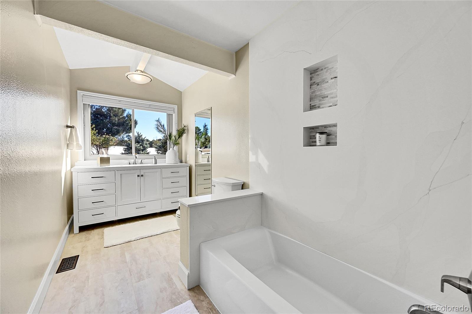 8717 Thunderbird Circle Parker, CO 80134 - Photo 23 of 50 a bathroom with a bathtub sink and mirror