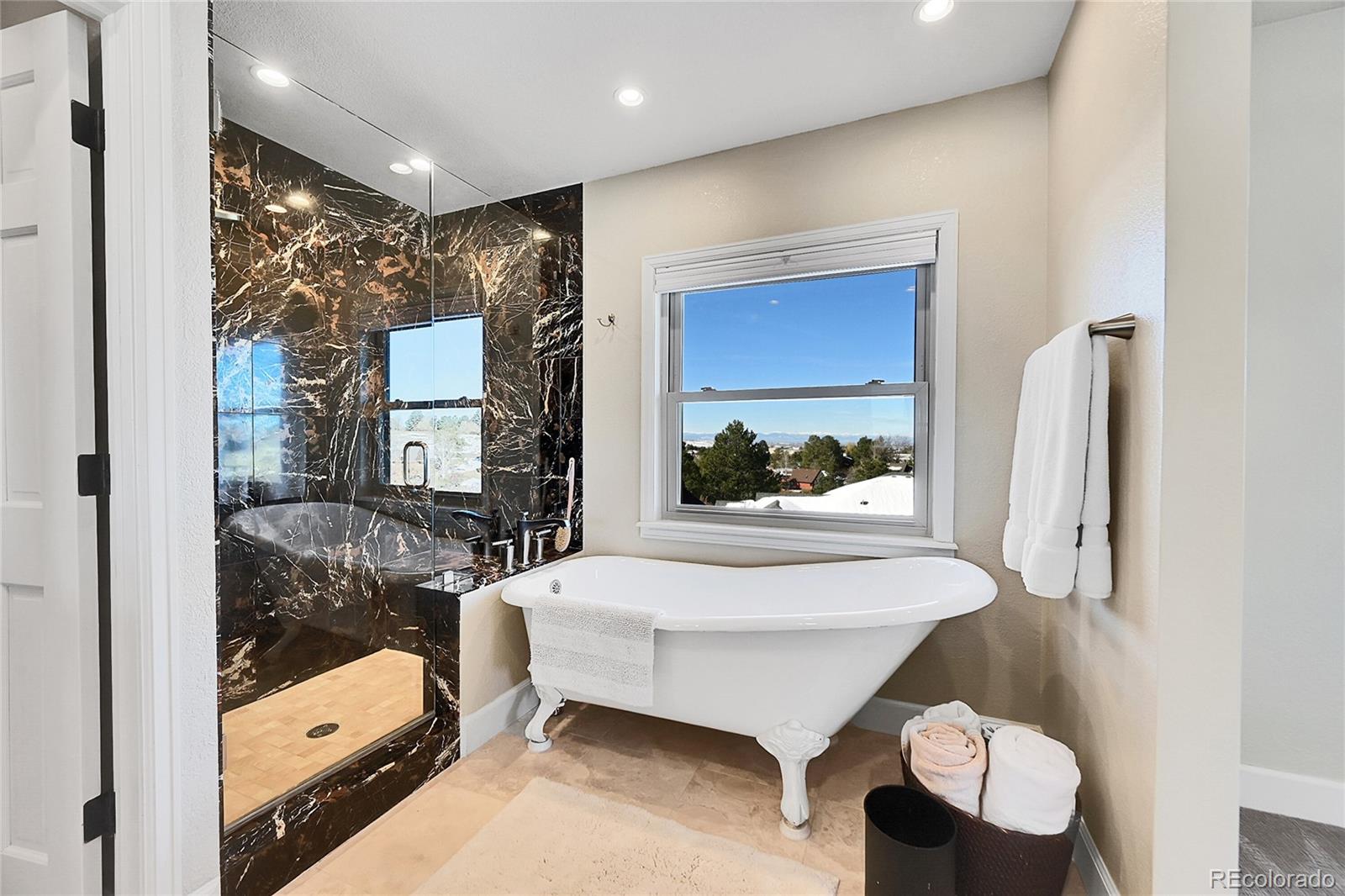 8717 Thunderbird Circle Parker, CO 80134 - Photo 28 of 50 a en suite bathroom with a tub shower and sink