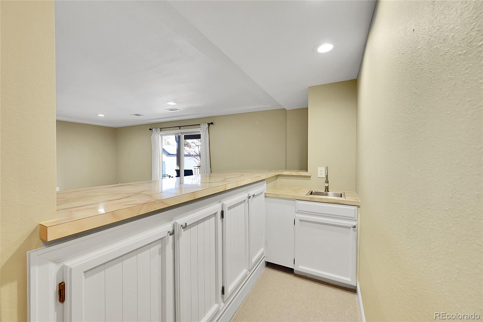 8717 Thunderbird Circle Parker, CO 80134 - Photo 34 of 50 a hall with a sink and cabinets