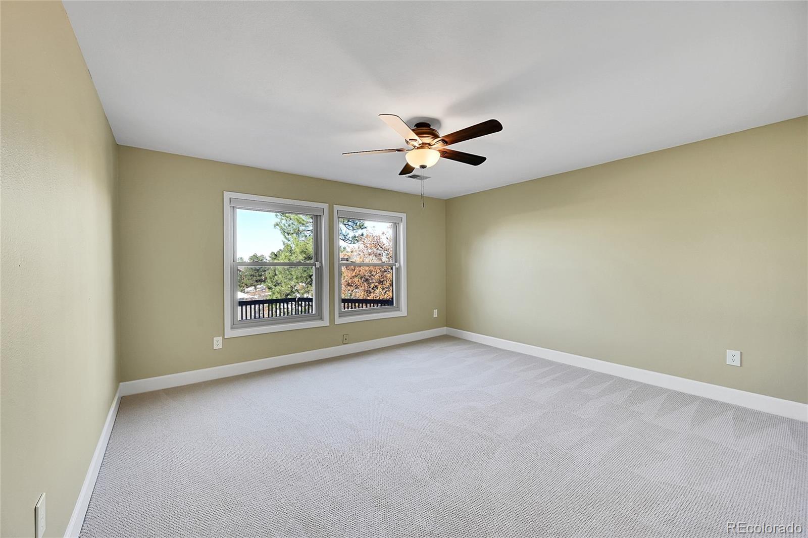 8717 Thunderbird Circle Parker, CO 80134 - Photo 36 of 50 an empty room with windows and ceiling fan