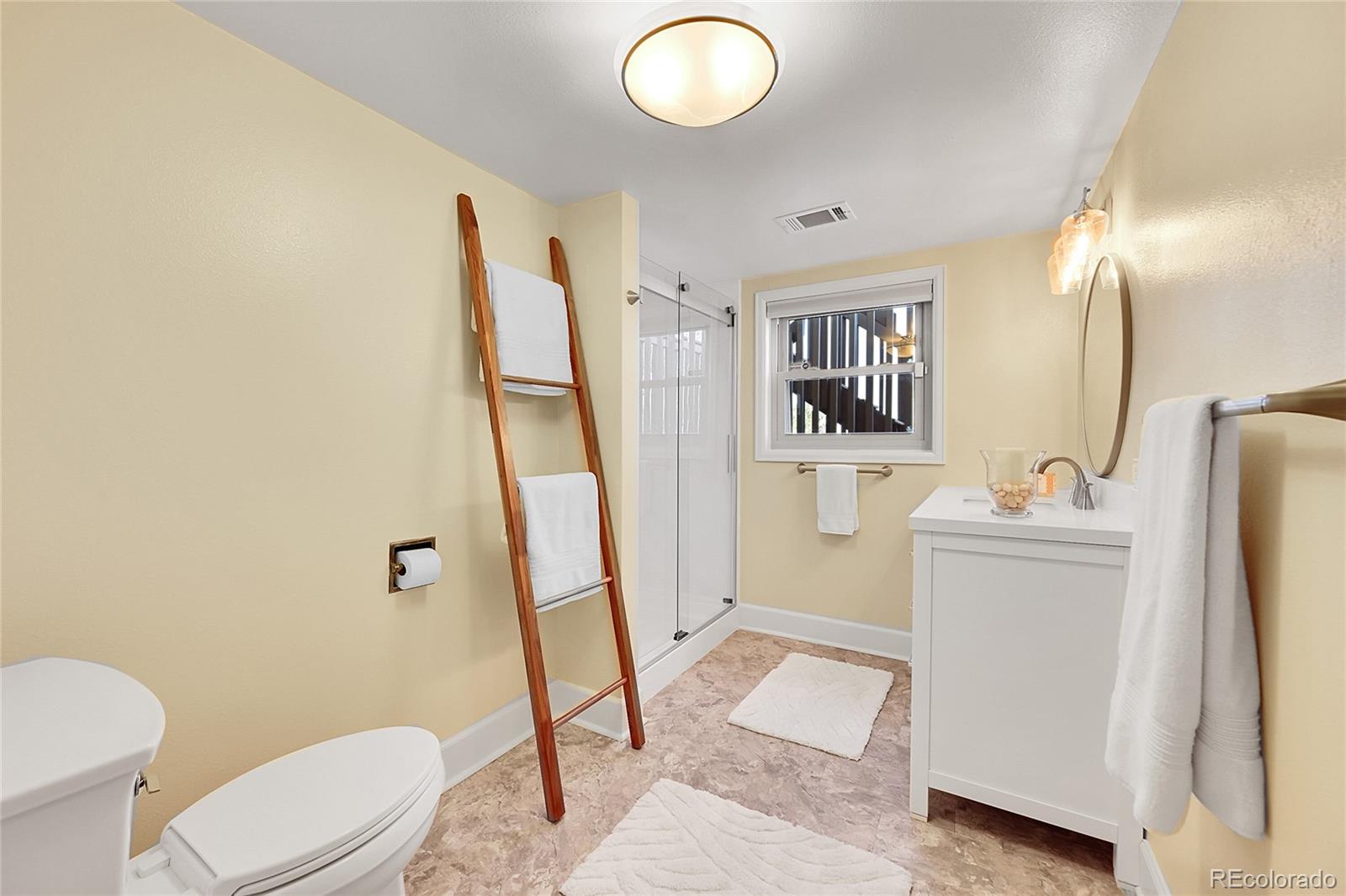 8717 Thunderbird Circle Parker, CO 80134 - Photo 37 of 50 a bathroom with a sink a toilet and a mirror