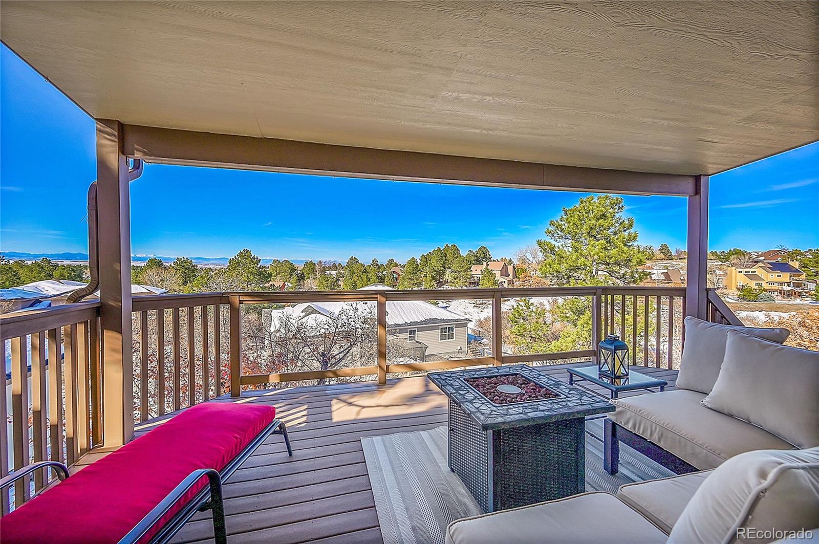 8717 Thunderbird Circle Parker, CO 80134 - Photo 40 of 50 a view of a balcony with furniture and a floor to ceiling window
