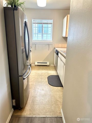 a kitchen with a refrigerator and a sink