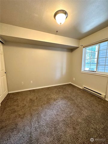 an empty room with a empty space and windows