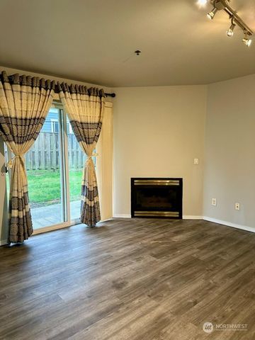 a view of empty room with wooden floor and a floor to ceiling window