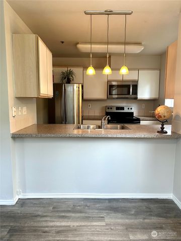a kitchen with a refrigerator a sink and a stove