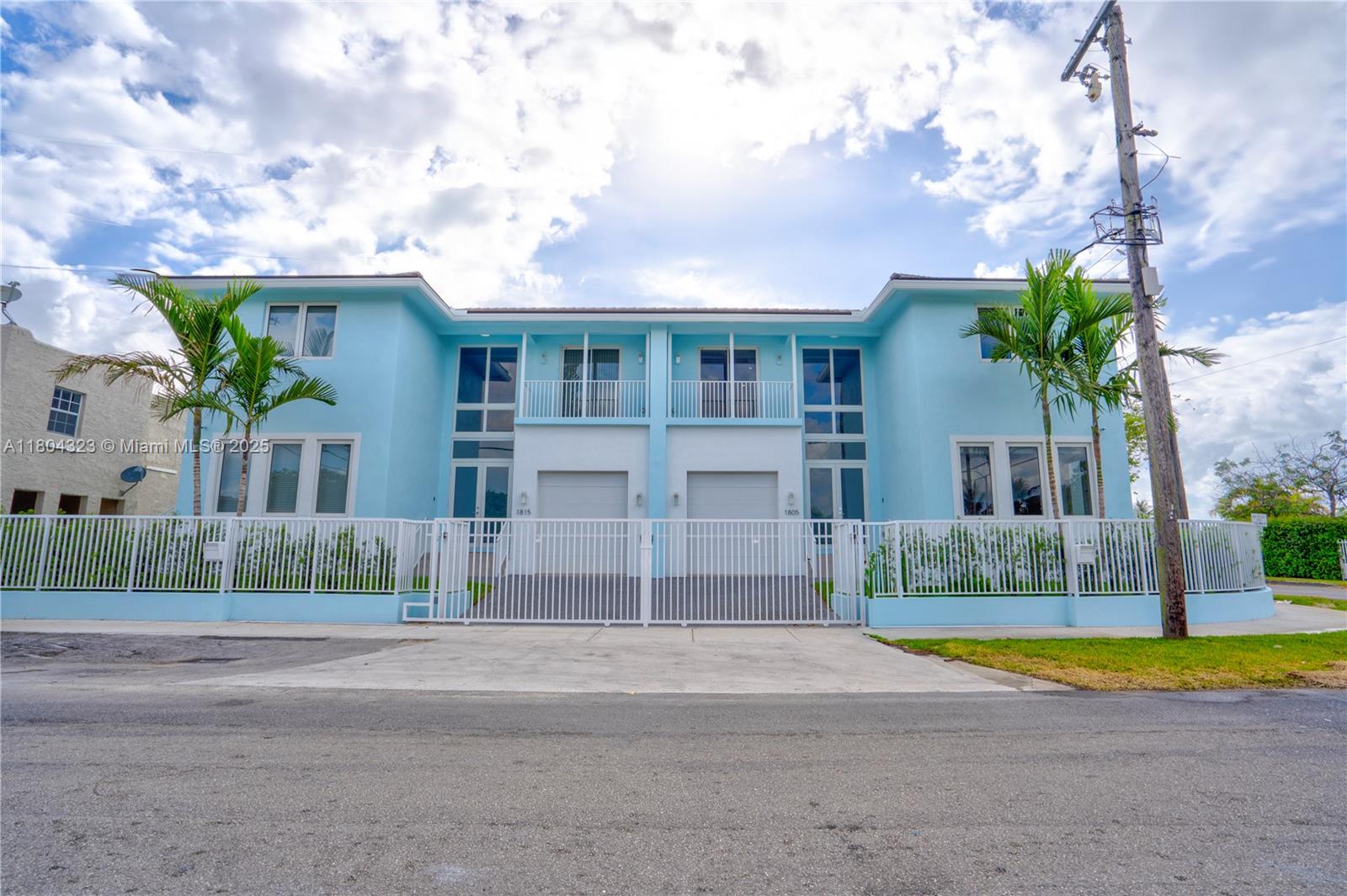 1805 Northwest 22nd Court Miami, FL 33125 - Photo 1 of 58 a view of house with a yard and potted plants