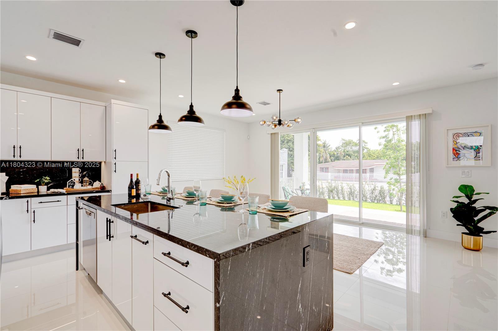 1805 Northwest 22nd Court Miami, FL 33125 - Photo 13 of 58 a kitchen with a sink a counter top space and stainless steel appliances