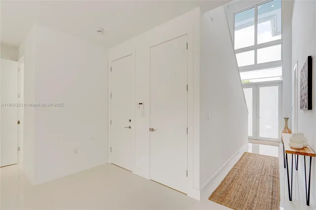 a view of a hallway with paintings on the wall