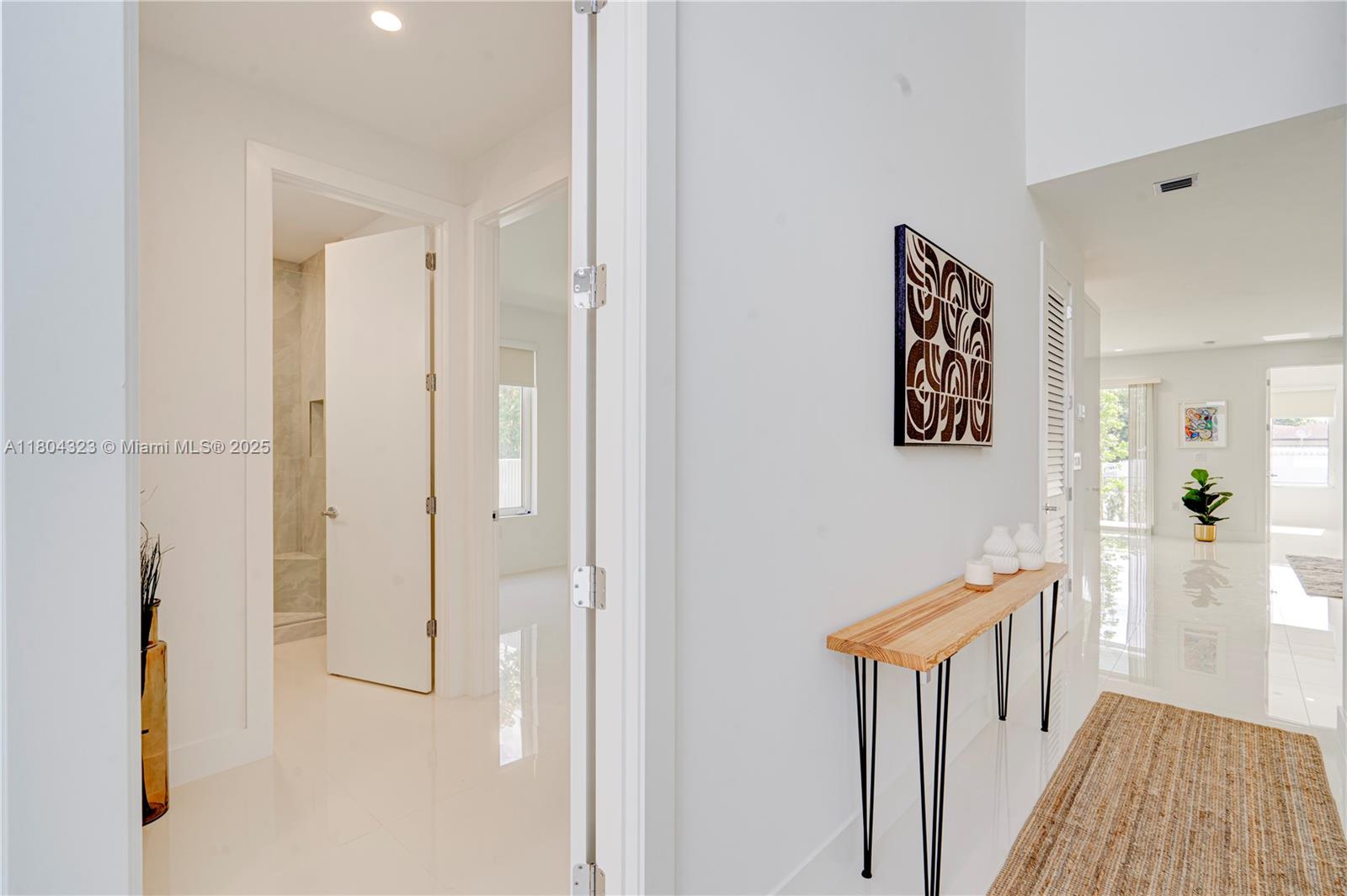 1805 Northwest 22nd Court Miami, FL 33125 - Photo 31 of 58 a view of a hallway with paintings on the wall