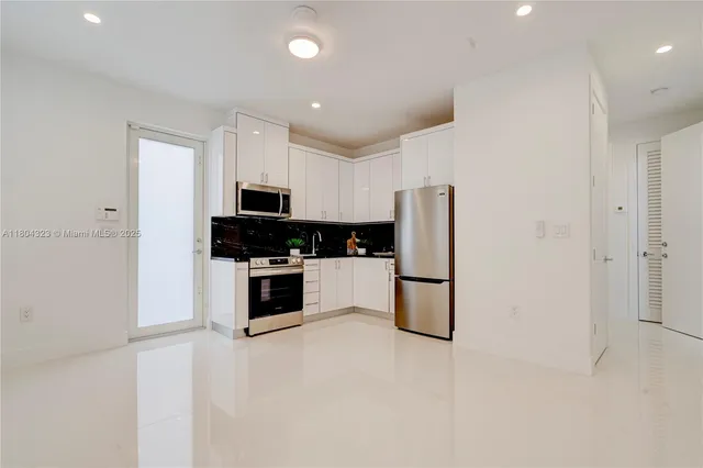 a view of a hallway with washer and dryer