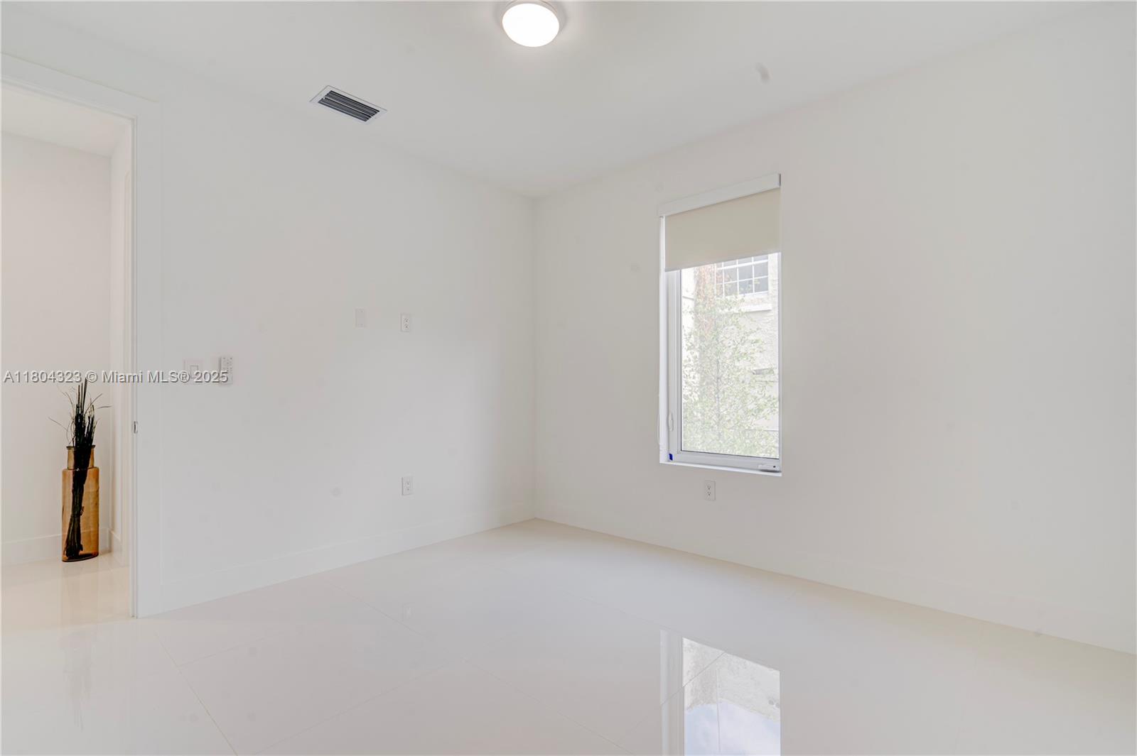 1805 Northwest 22nd Court Miami, FL 33125 - Photo 34 of 58 a view of an empty room with a window