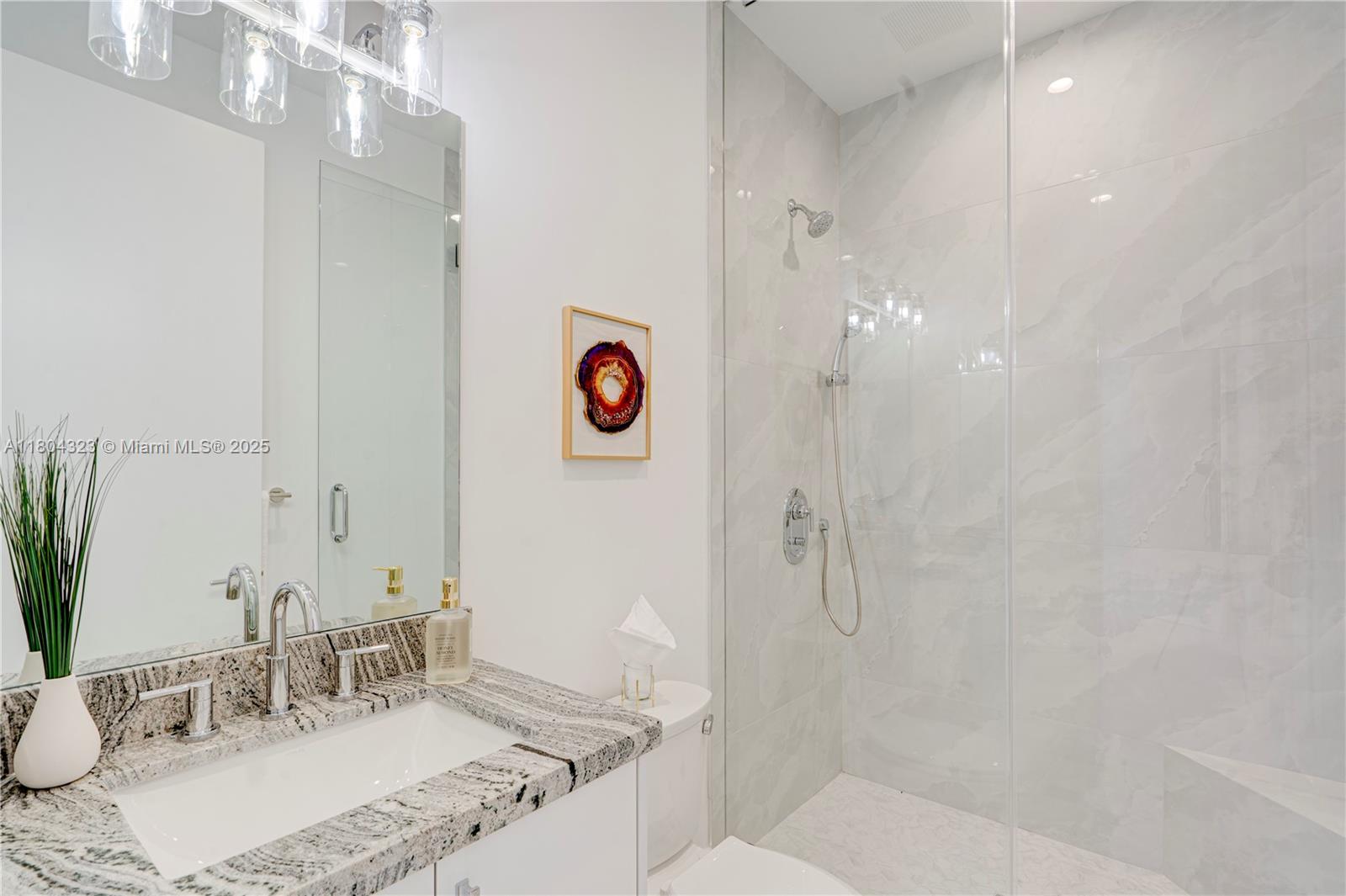 1805 Northwest 22nd Court Miami, FL 33125 - Photo 36 of 58 a bathroom with a granite countertop sink and a mirror