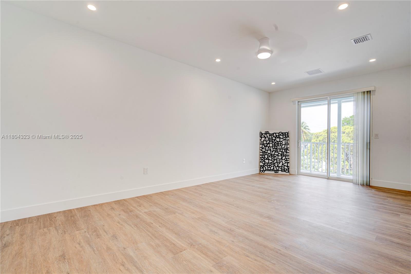 1805 Northwest 22nd Court Miami, FL 33125 - Photo 39 of 58 a view of an empty room with wooden floor and a window