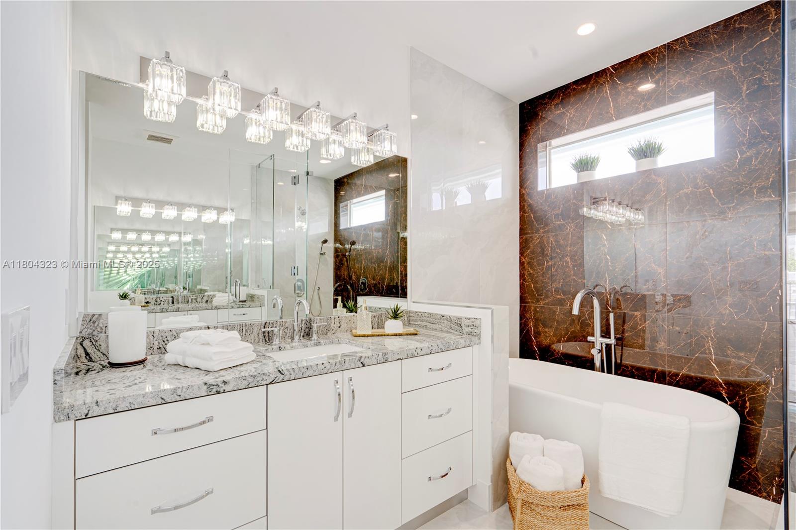 1805 Northwest 22nd Court Miami, FL 33125 - Photo 47 of 58 a bathroom with a granite countertop sink a toilet a mirror and shower