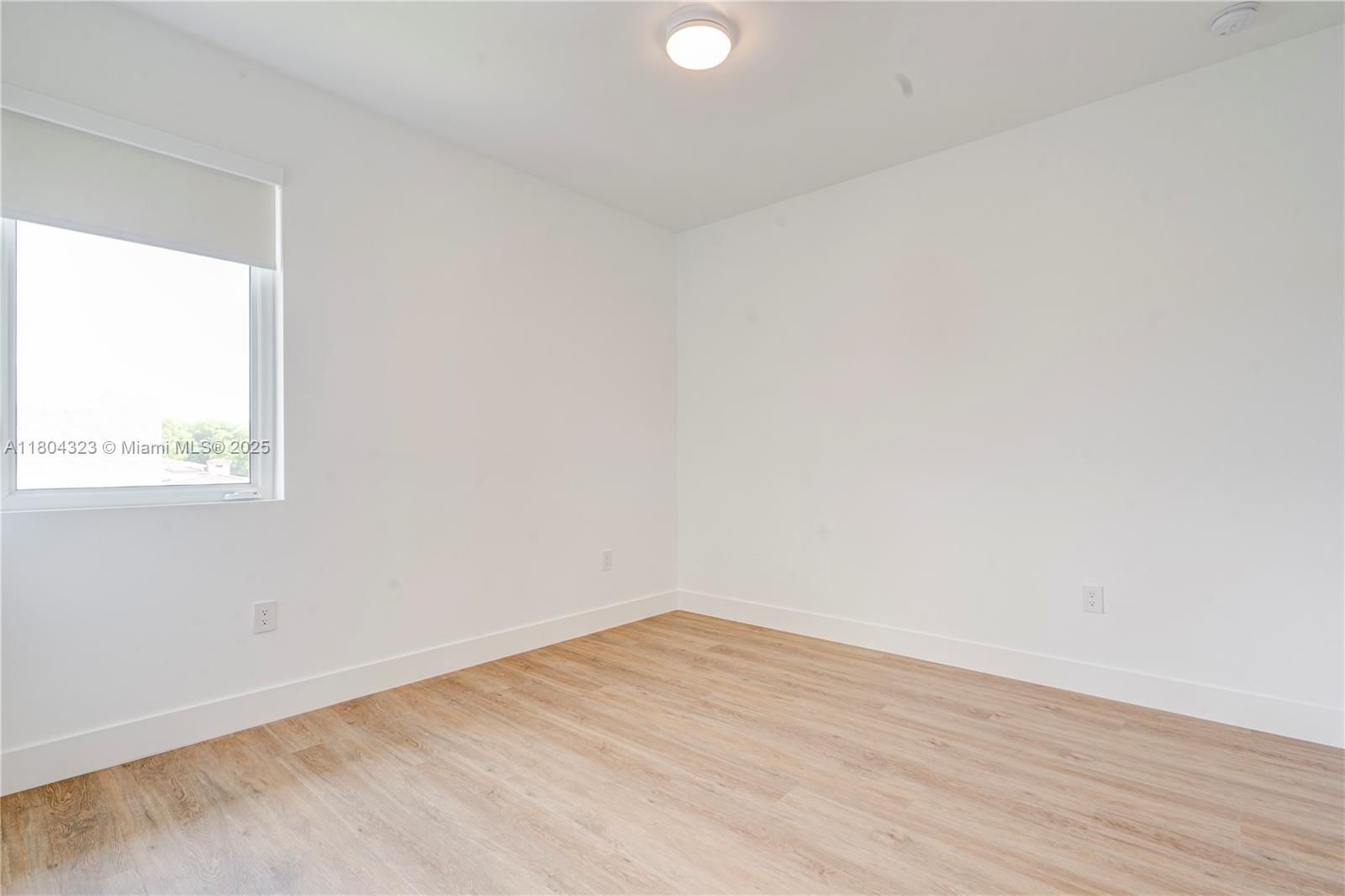 1805 Northwest 22nd Court Miami, FL 33125 - Photo 50 of 58 an empty room with wooden floor and windows