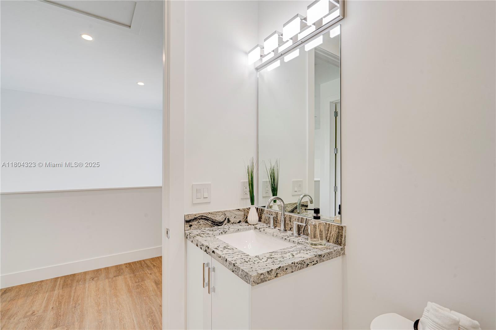 1805 Northwest 22nd Court Miami, FL 33125 - Photo 53 of 58 a bathroom with a sink and a mirror