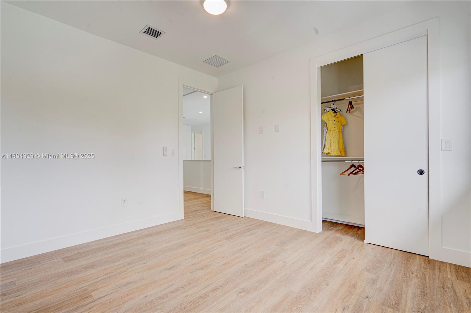 1805 Northwest 22nd Court Miami, FL 33125 - Photo 55 of 58 an empty room with wooden floor and entrance