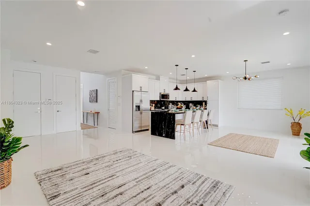 a large white kitchen with lots of counter space and appliances