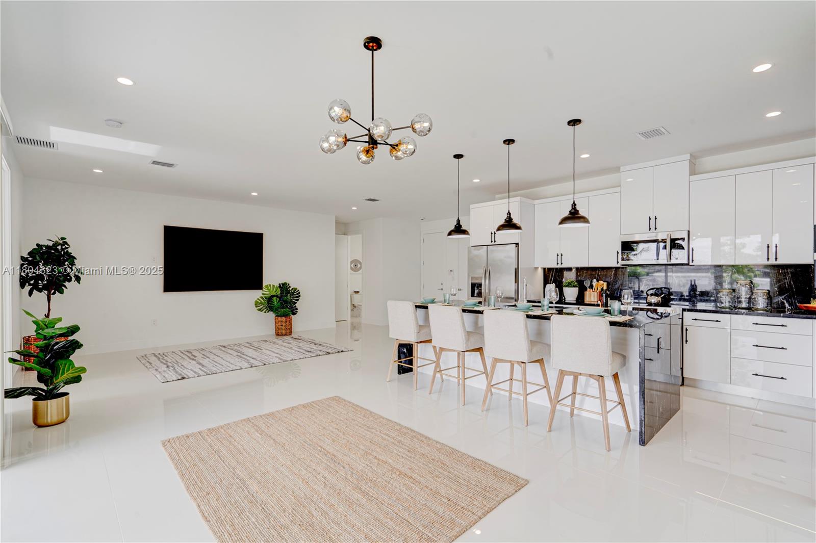 1805 Northwest 22nd Court Miami, FL 33125 - Photo 9 of 58 a large white kitchen with lots of counter space and appliances