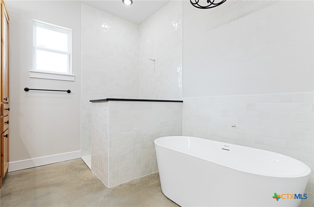 237 Cedar Bluff Loop Gatesville, TX 76528 - Photo 12 of 31 a bathroom with a bathtub and a shower