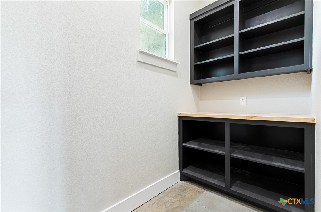 237 Cedar Bluff Loop Gatesville, TX 76528 - Photo 16 of 31 a view of walk in closet with empty racks