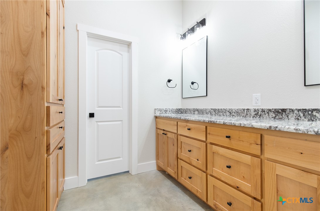 237 Cedar Bluff Loop Gatesville, TX 76528 - Photo 19 of 31 a bathroom with a granite countertop sink and a mirror