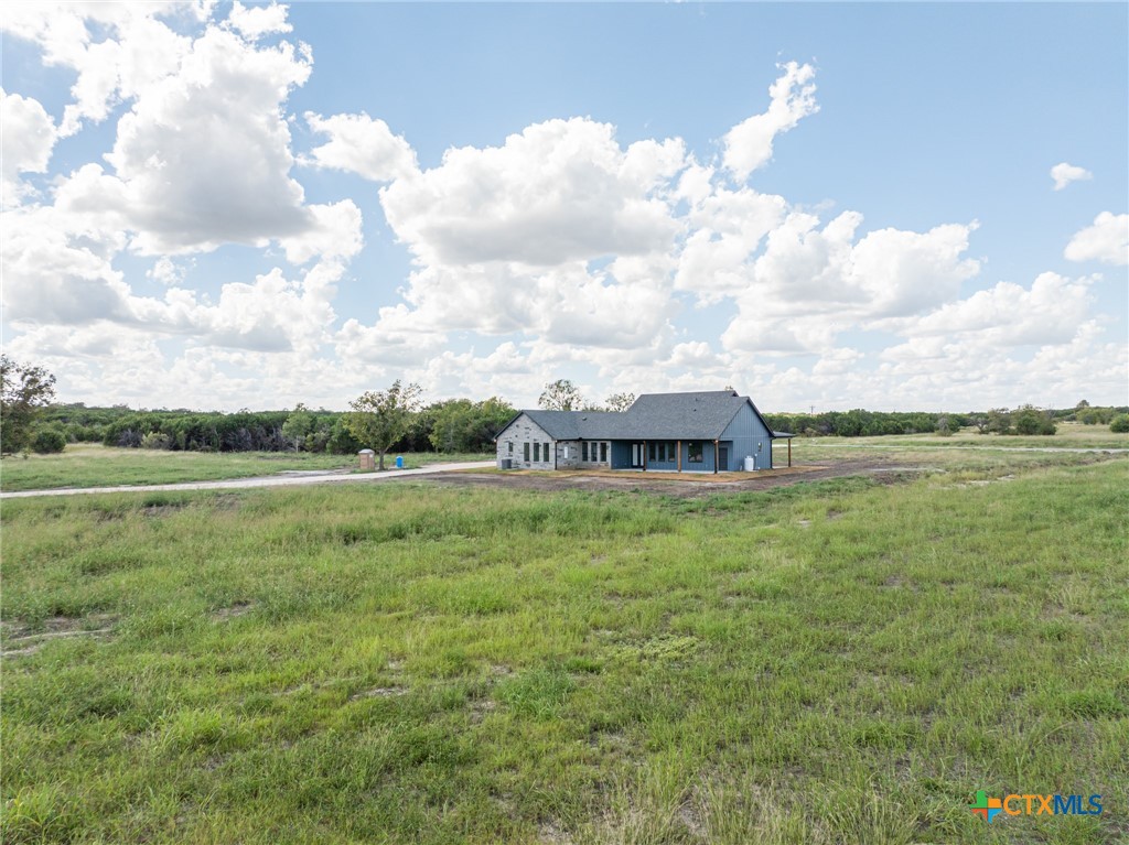 237 Cedar Bluff Loop Gatesville, TX 76528 - Photo 29 of 31 a view of a large garden with plants and a large tree