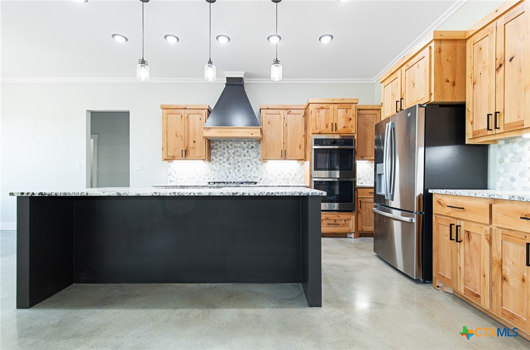 237 Cedar Bluff Loop Gatesville, TX 76528 - Photo 6 of 31 a kitchen with stainless steel appliances kitchen island granite countertop a refrigerator a stove and a sink