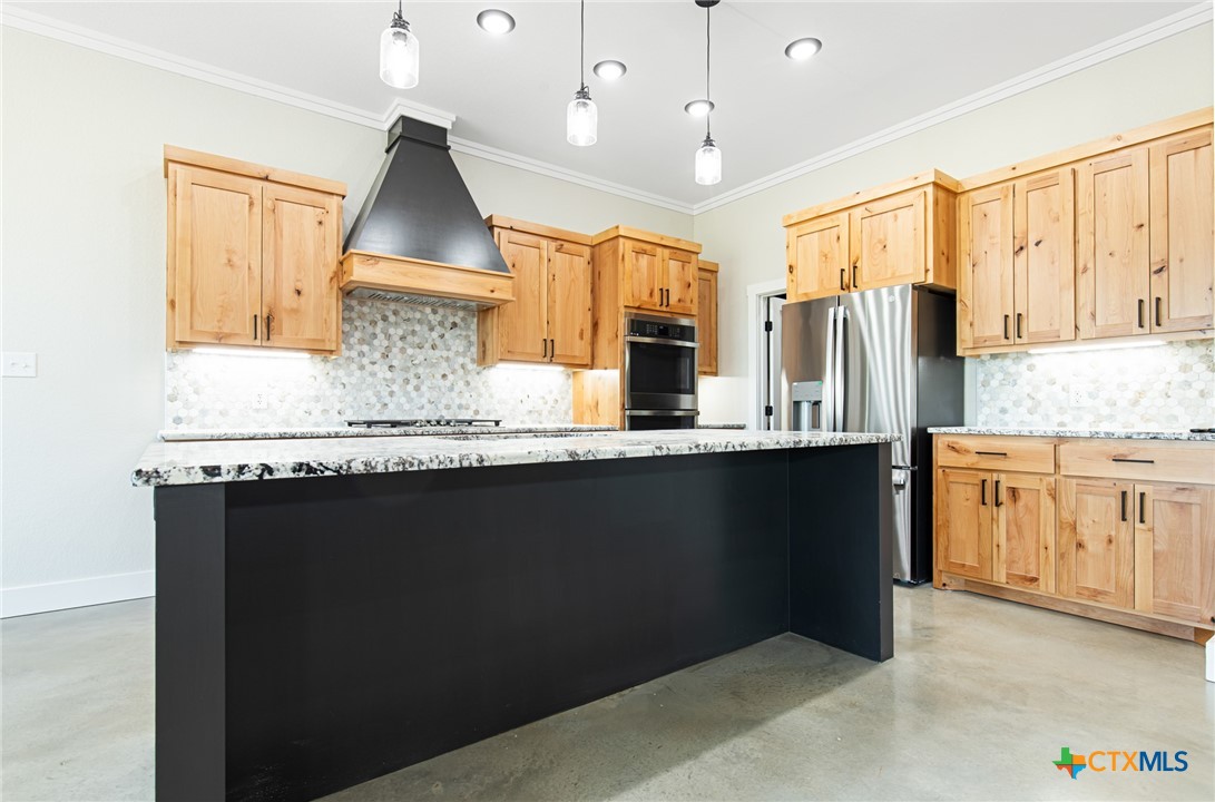 237 Cedar Bluff Loop Gatesville, TX 76528 - Photo 7 of 31 a kitchen with granite countertop a sink a window stainless steel appliances and cabinets