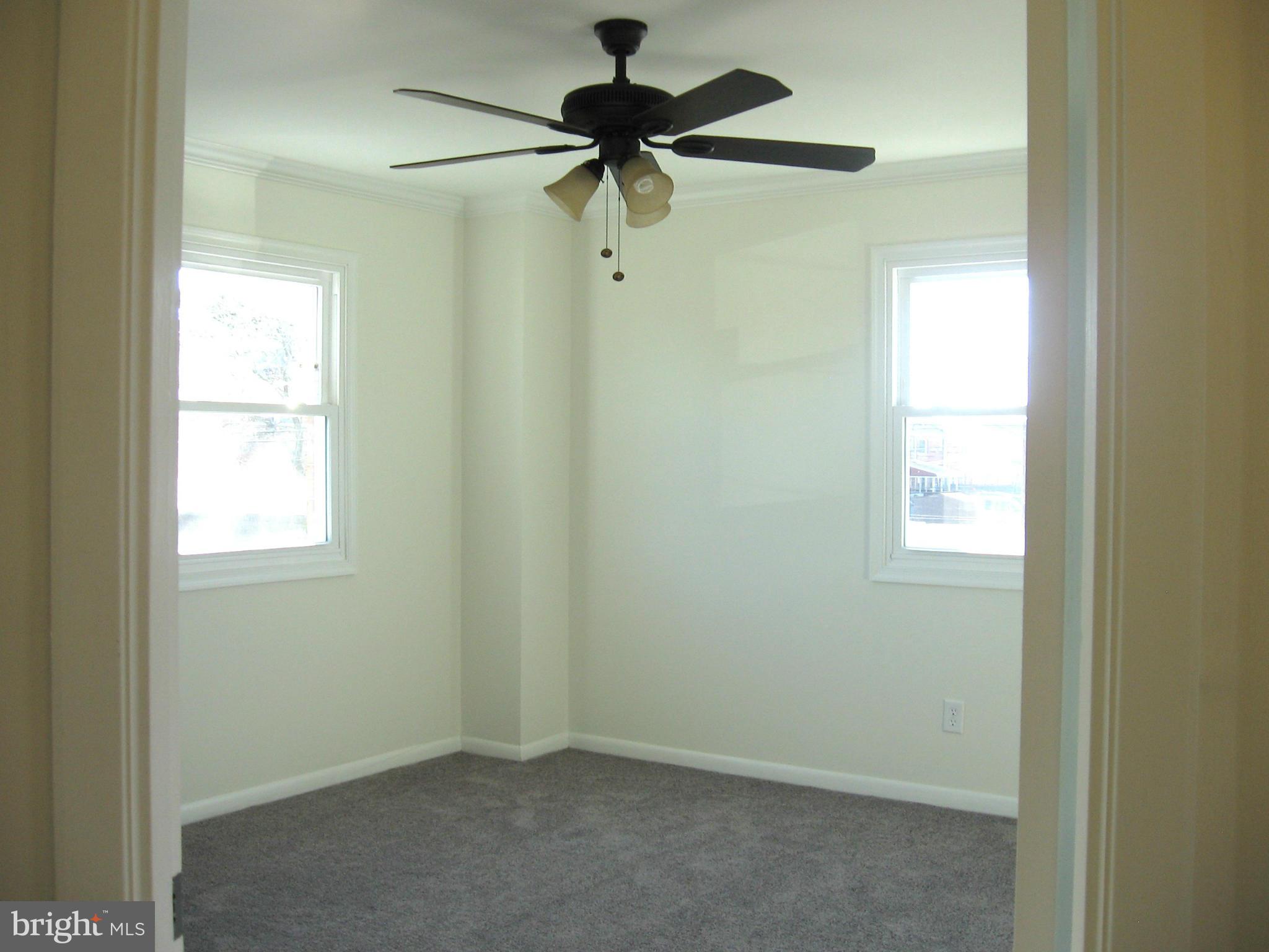 8245 Del Haven Road Baltimore, MD 21222 - Photo 11 of 29 a view of a chandelier fan and a window