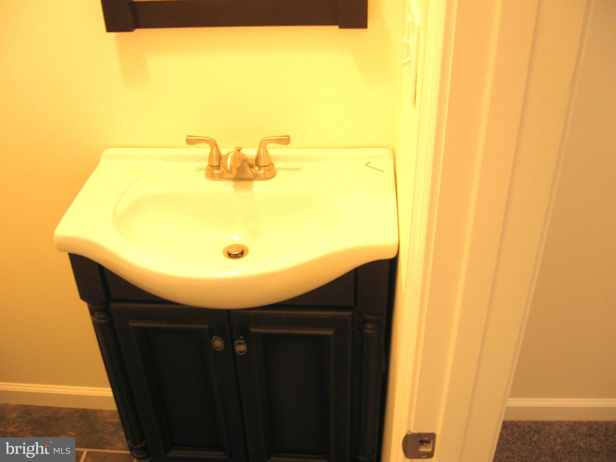 8245 Del Haven Road Baltimore, MD 21222 - Photo 18 of 29 a bathroom with a sink and a mirror