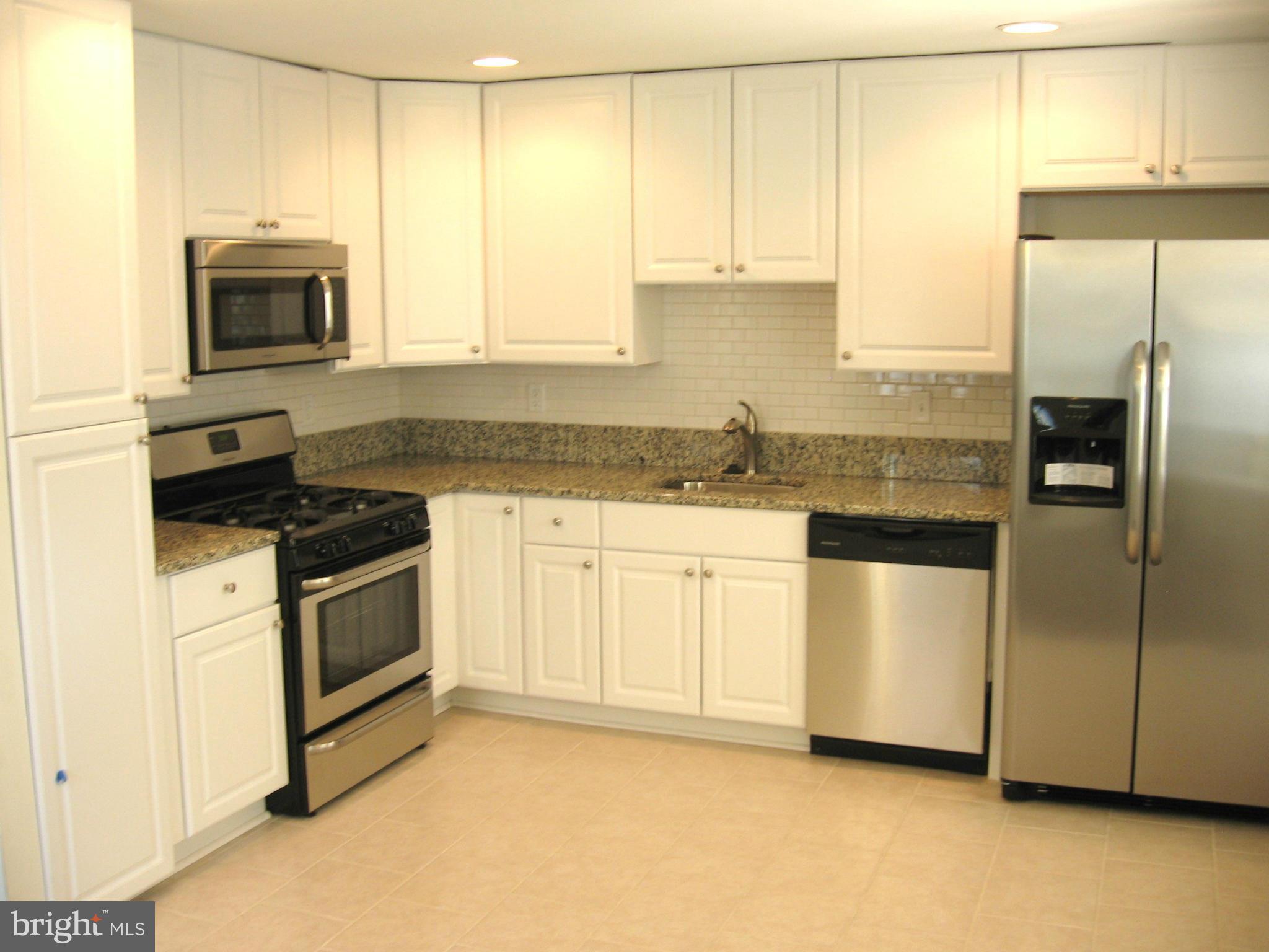 8245 Del Haven Road Baltimore, MD 21222 - Photo 4 of 29 a kitchen with stainless steel appliances granite countertop a stove a sink and a microwave