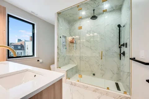 a bathroom with a bathtub and a shower