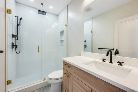 a bathroom with a sink toilet and shower