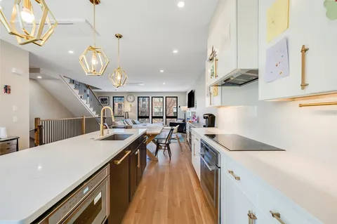 a kitchen with lots of counter space a sink and appliances