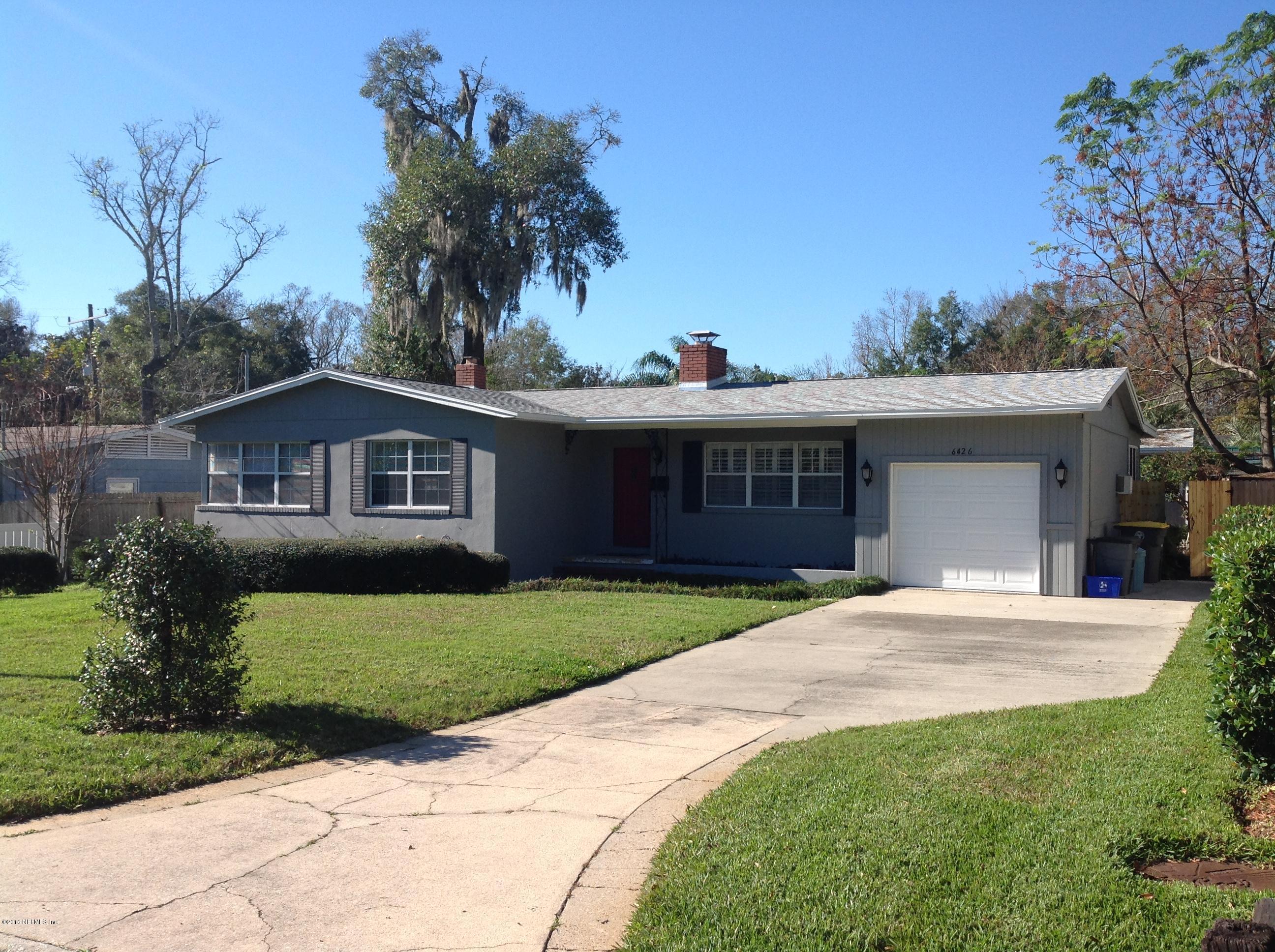 6426 Wesleyan Road Jacksonville, FL 32217 - Photo 1 of 4 a front view of a house with a garden and yard
