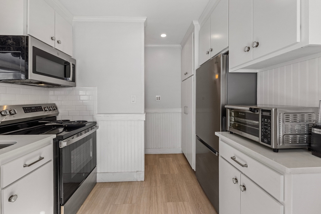 34 Lafayette Street Marblehead, MA 01945 - Photo 11 of 22 a kitchen with stainless steel appliances a stove microwave and refrigerator
