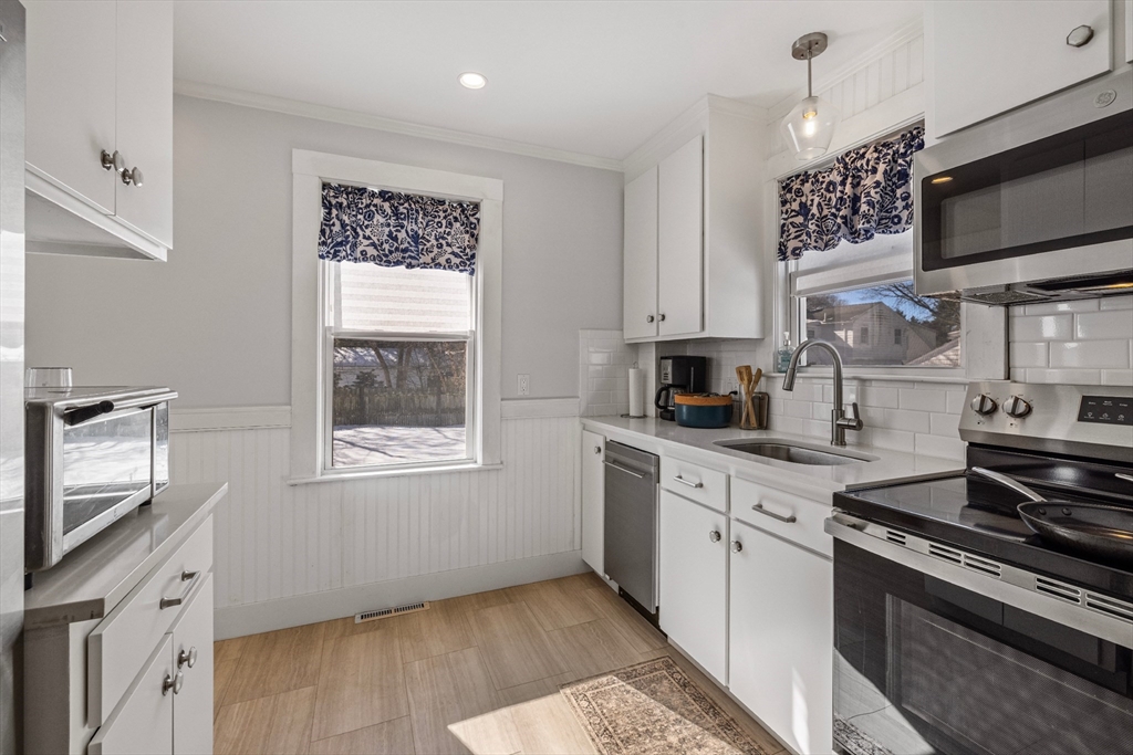 34 Lafayette Street Marblehead, MA 01945 - Photo 12 of 22 a kitchen with stainless steel appliances granite countertop a sink stove and microwave