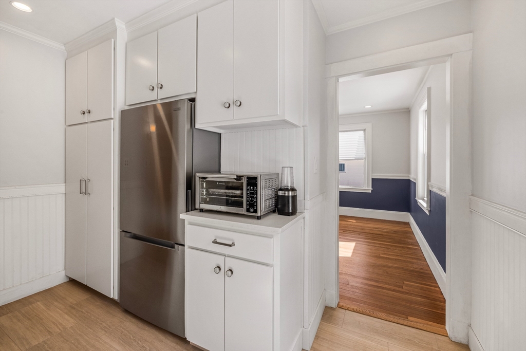 34 Lafayette Street Marblehead, MA 01945 - Photo 13 of 22 a kitchen with stainless steel appliances a refrigerator a stove and white cabinets